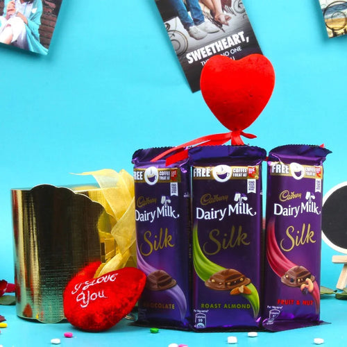 Three Cadbury Dairy Milk Silk chocolate bars with a red heart 