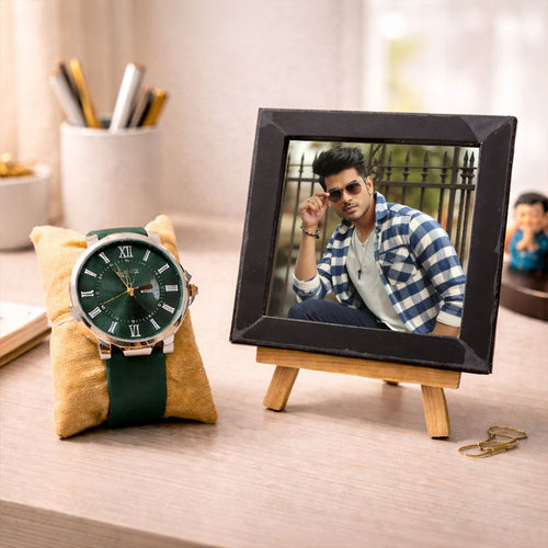 Green wristwatch on a yellow cushion next to a digital photo frame displaying a man's face.