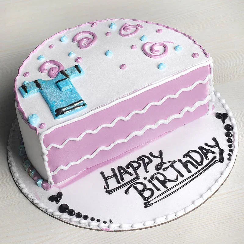 Birthday cake with pink and white frosting, blue car decoration, and 'Happy Birthday' text.