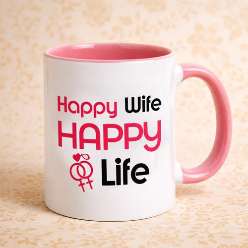 White mug with pink interior and handle, featuring text 'Happy Wife Happy Life' on a beige background.