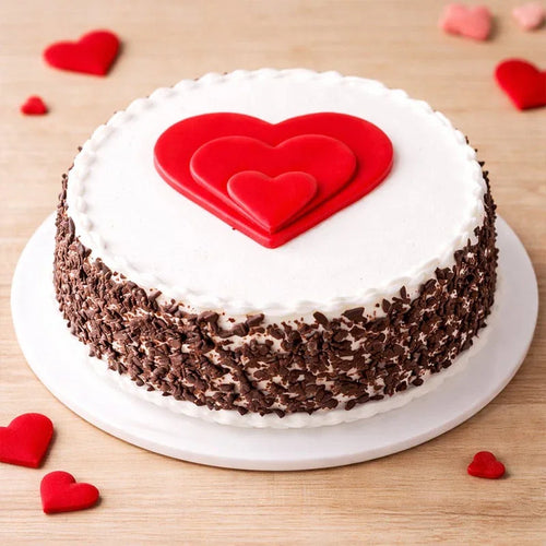 Cake with red heart design on a wooden surface
