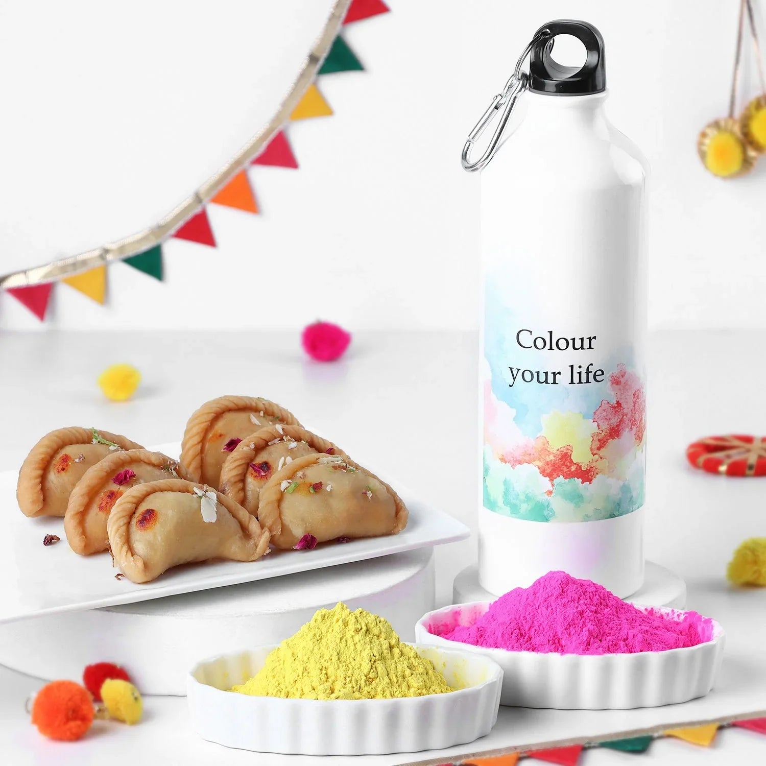 Colorful water bottle with 'Colour your life' text, cookies, and powders on a white background