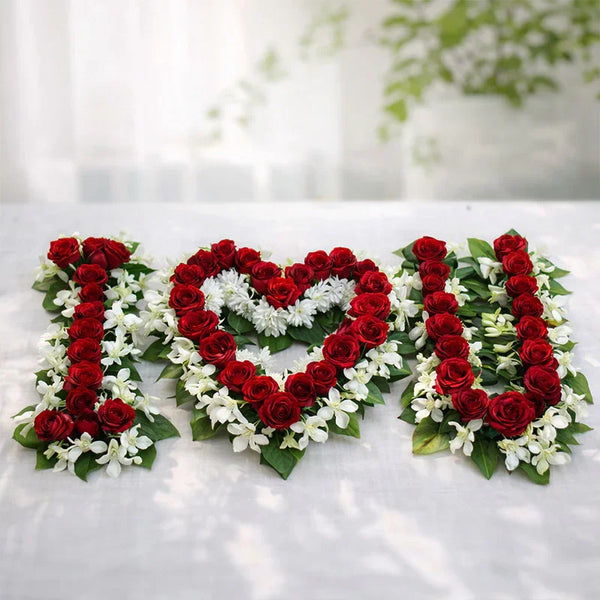 Red rose and white flower arrangement spelling I love you on a white background, romantic gift