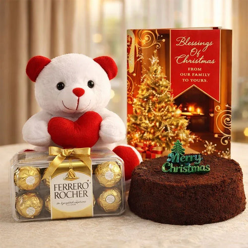 White teddy bear with red heart, Ferrero Rocher chocolates, Christmas cake, and Christmas card on a light background.