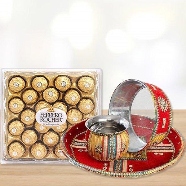 Box of Ferrero Rocher chocolates and a decorative tray with a candle 