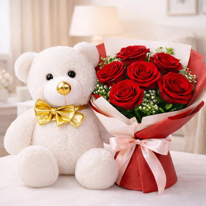 White teddy bear with gold bow and bouquet of red roses on table, perfect gift combo