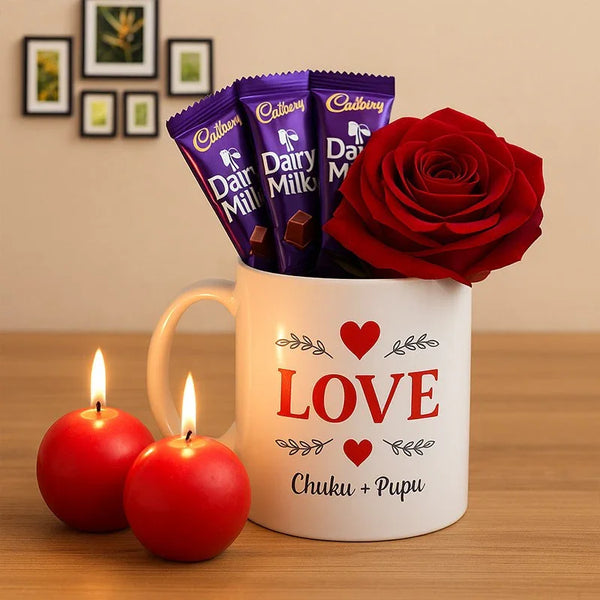 Romantic gift set with a love mug, red rose, Dairy Milk chocolates, and two red candles.