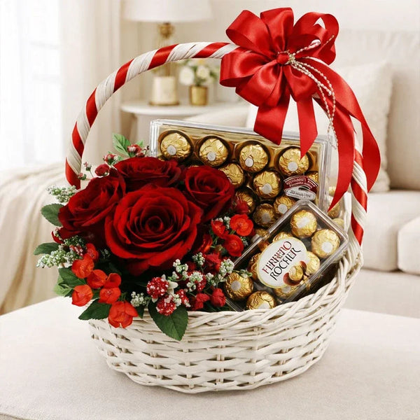 Gift basket with Ferrero Rocher chocolates, red roses, red ribbon and flowers, in a cozy room.