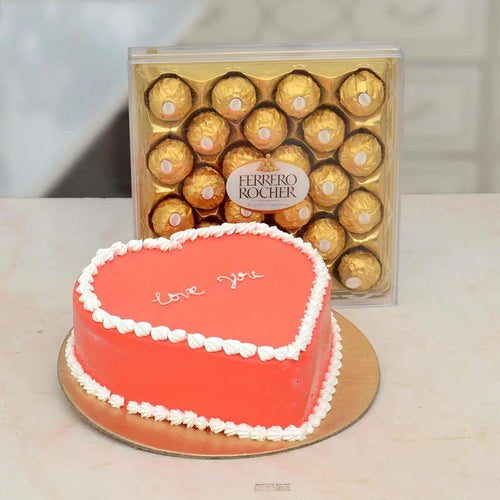 Heart-shaped cake with 'love you' text and a box of Ferrero Rocher chocolates on a light background