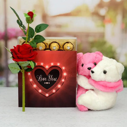 Valentine's Day gift set with roses, chocolates, and teddy bears on a blurred background