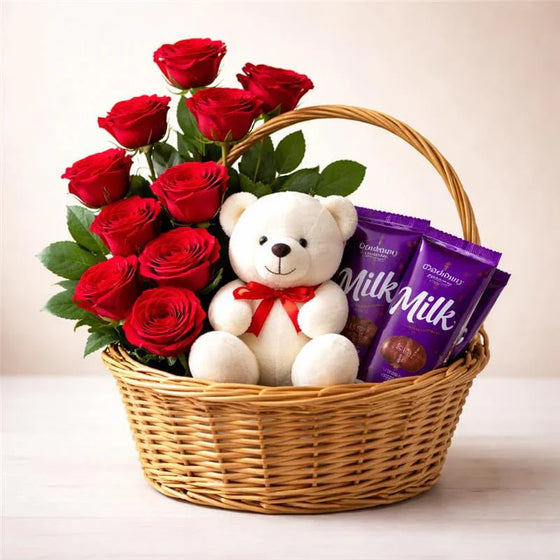 Gift basket with red roses, white teddy bear with red bow, and chocolate bars