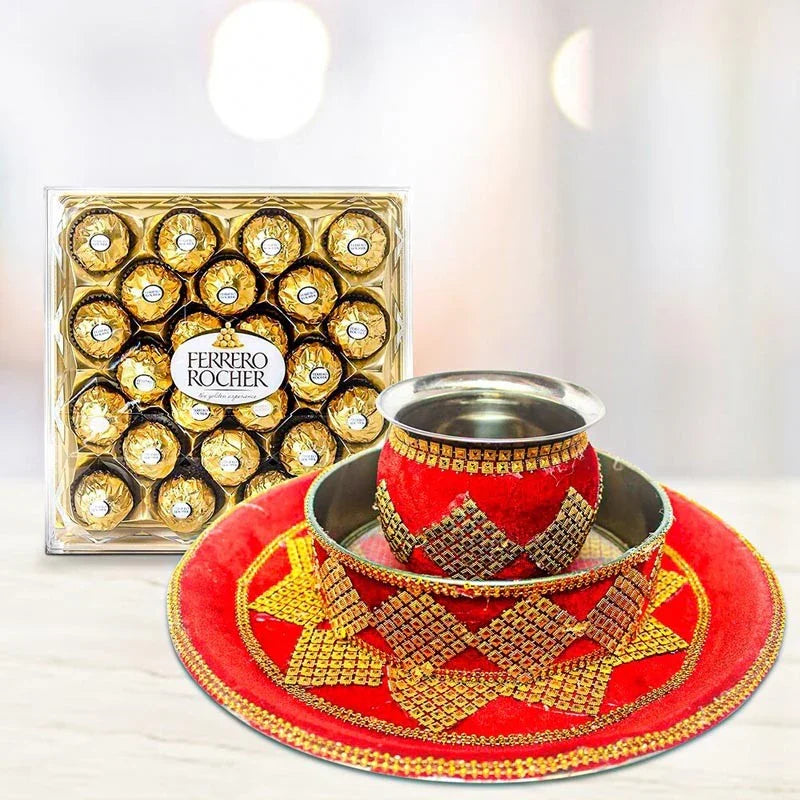 Decorative tea set with red and gold tray and cup, Ferrero Rocher chocolate box in the background.