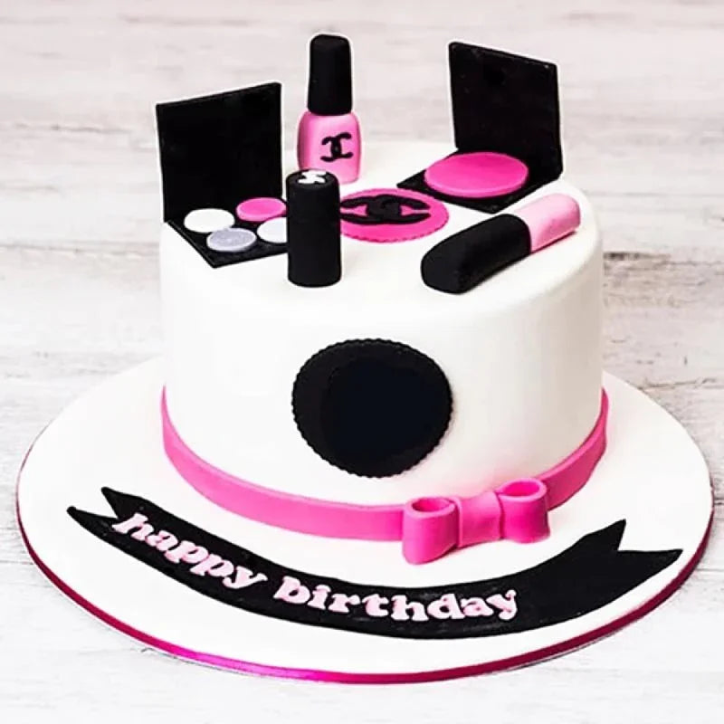 Makeup-themed birthday cake with pink and black accents on a white background