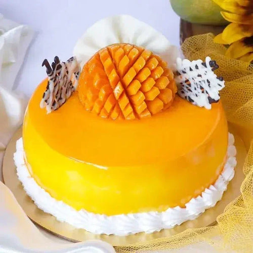 Mango cake with decorative elements on a white background