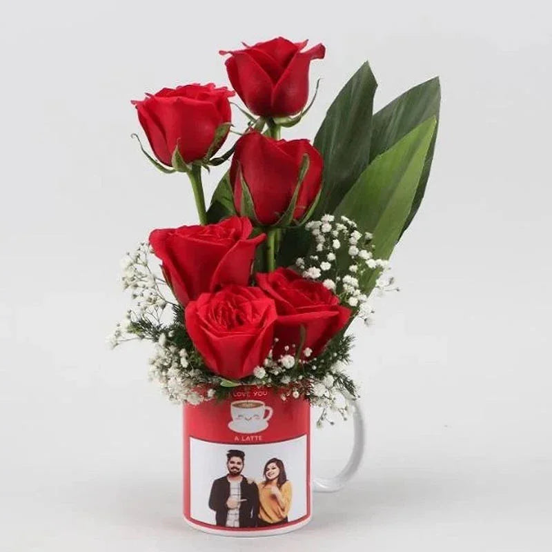 Red roses in a cylindrical container with a printed label on a white background