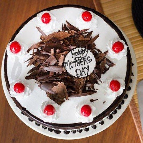 Chocolate shavings cake with cherries and Happy Mothers Day message, top view