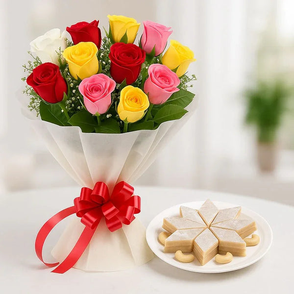 Mixed roses bouquet with red, pink, yellow, and white roses and a plate of kaju katli sweets