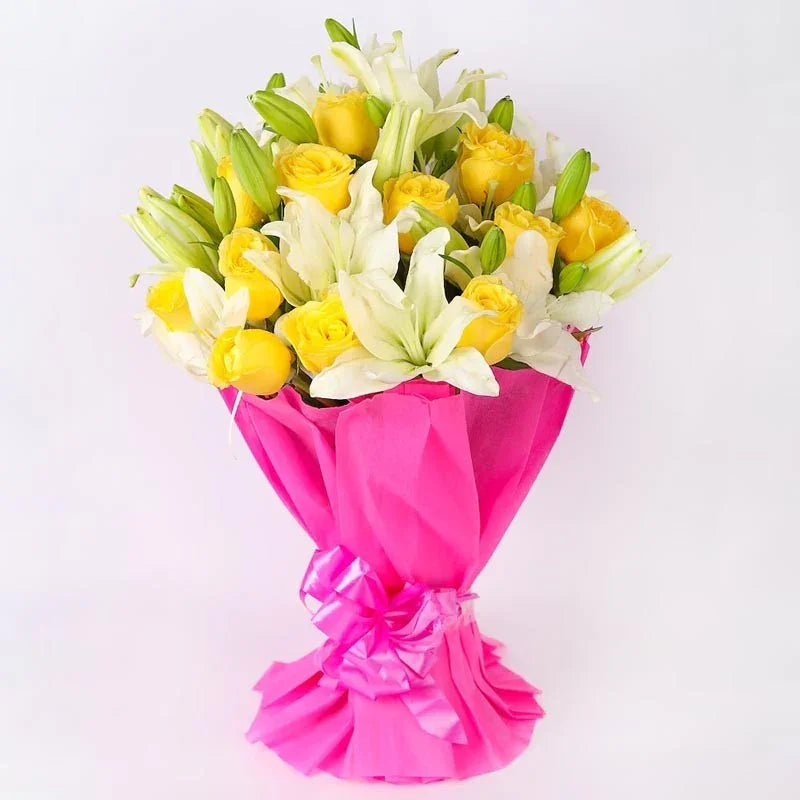 Bouquet of yellow and white flowers wrapped in pink paper on a light gray background