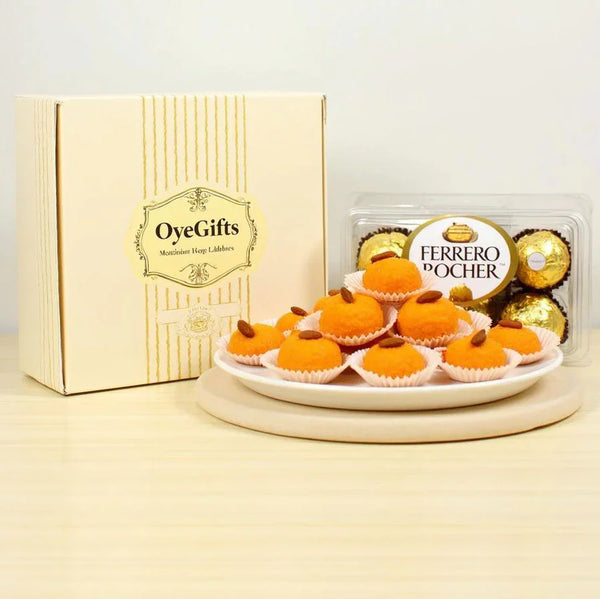 Motichoor laddoo sweets on a plate with Ferrero Rocher chocolates in gift packaging