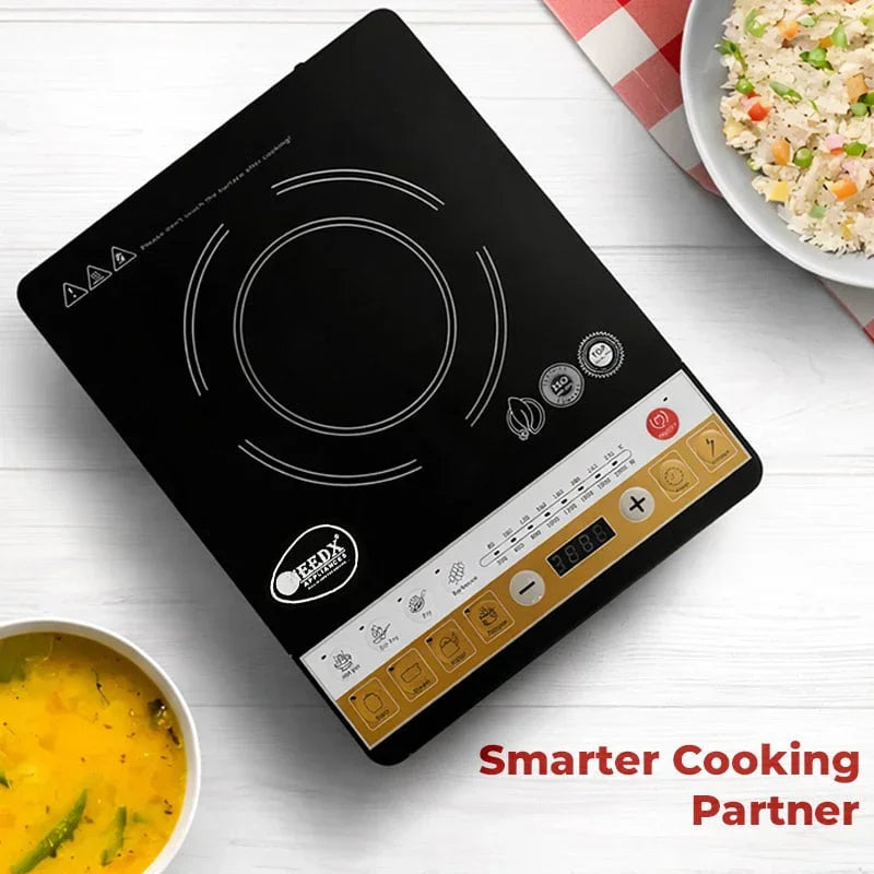 Portable induction cooktop with bowls of food on a white surface