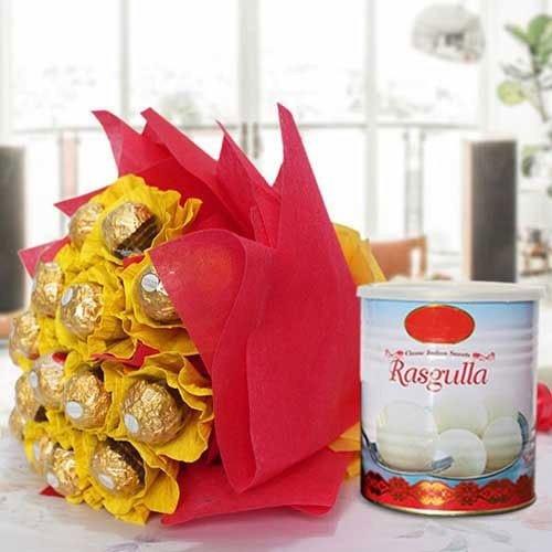 Bouquet of Ferrero Rocher chocolates wrapped in yellow paper and red tissue paper next to a container of Rasgulla.