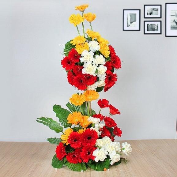 Floral Stand Arrangement with 20 Red Gerberas, 15 White Carnations & 15 Yellow Gerberas - Flower Delivery in GiftsGhaziabad