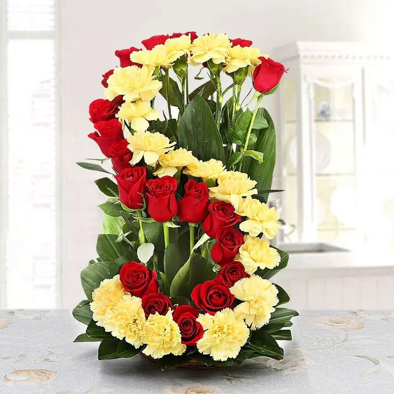 Floral arrangement of yellow carnations and red roses shaped as the number 8, ideal gift