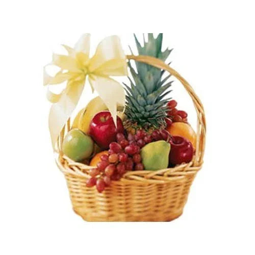 Wicker gift basket with pineapple, apples, grapes, guava, and a decorative bow
