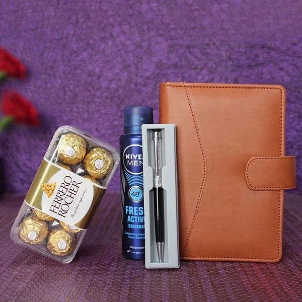 Gift set with Ferrero Rocher chocolates, Nivea Men deodorant, pen, and brown diary on purple background