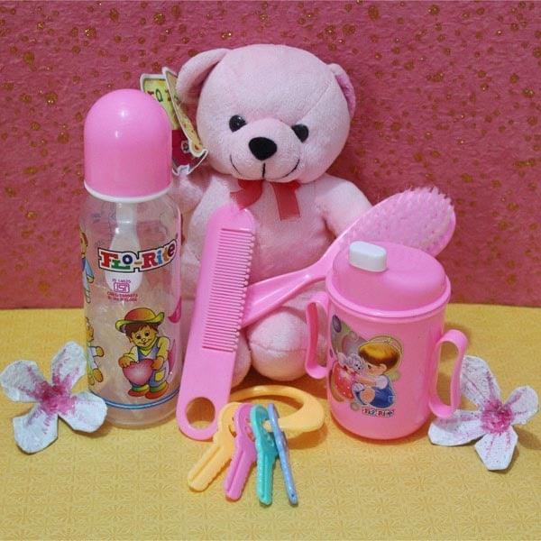 Baby gift set with pink teddy bear, feeding bottle, sipper cup, comb, brush and hairbands