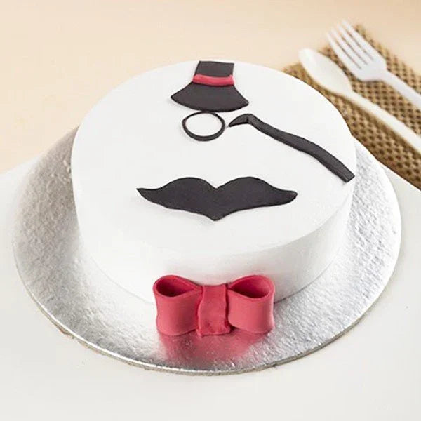 Gentleman theme fondant cake with mustache, bow tie, monocle, and top hat decorations