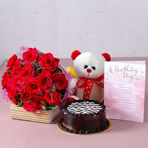 Birthday gift set with red rose bouquet, chocolate cake, teddy bear, and greeting card
