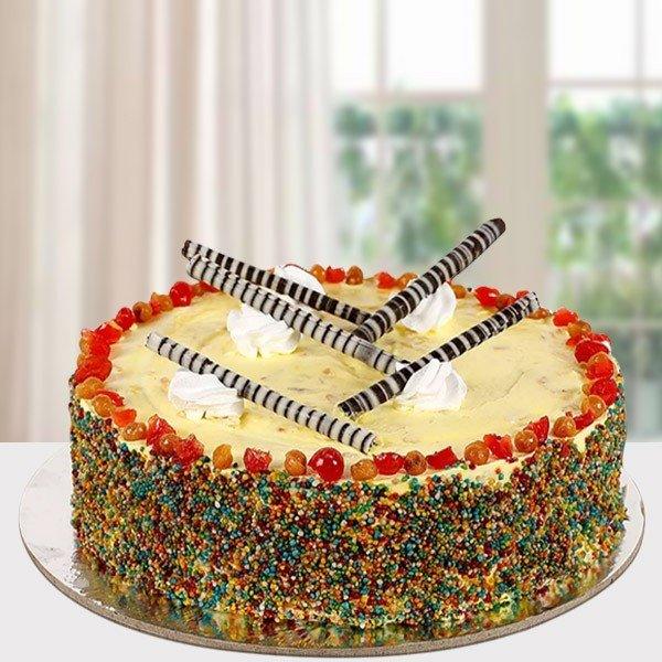 Colorful cake with candy decorations on a white surface