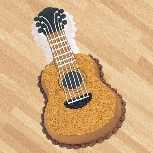Toy shaped like a guitar Cake  on a wooden floor