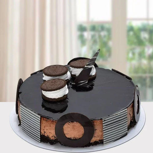 Chocolate cake with cookie decoration on a white surface