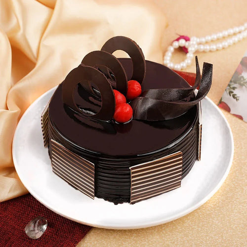 Chocolate cake with decorative elements on a white plate