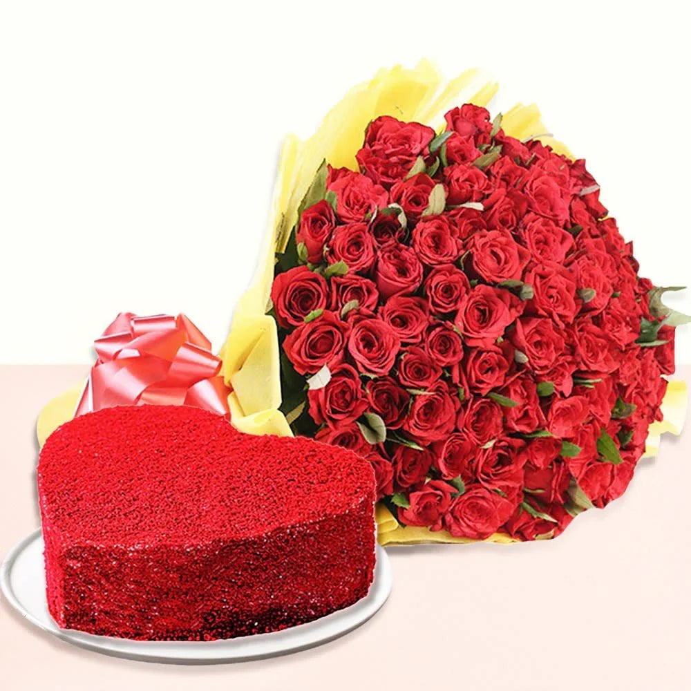 Heart-shaped red cake with a large bouquet of red roses