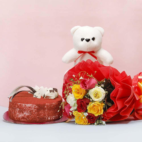 Red velvet cake, bouquet of flowers, and white teddy bear 