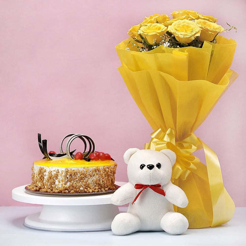 Bouquet of yellow roses, cake, and teddy bear 