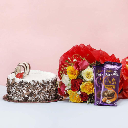 Cake, bouquet of flowers, and Cadbury Dairy Milk chocolate bars 