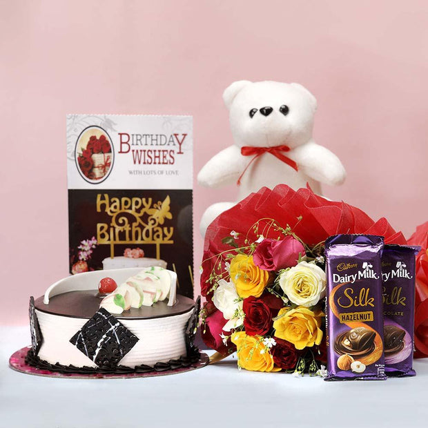 Birthday cake, teddy bear, bouquet of flowers, and chocolate bars Birthday Card