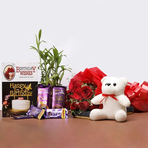 Birthday gift set with teddy bear, flowers, and chocolate bars 