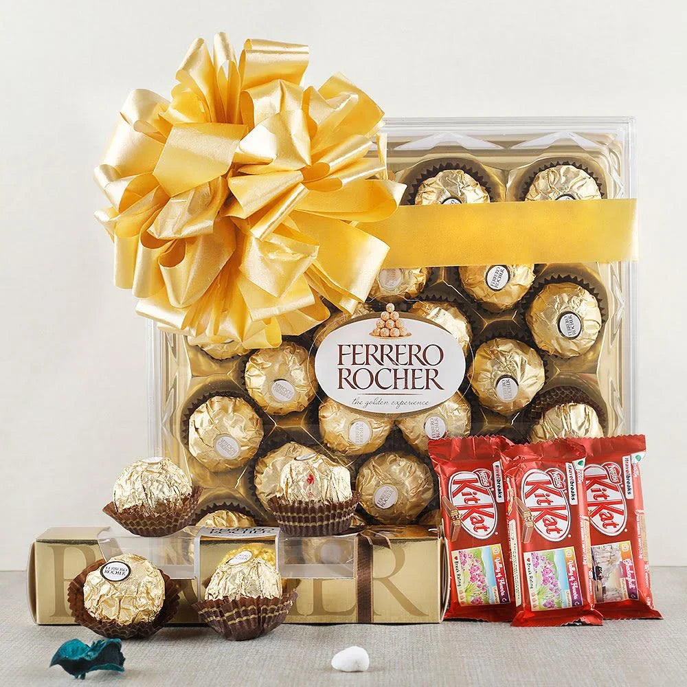 Ferrero Rocher chocolate box with a large yellow bow and Kit Kat bars on a 