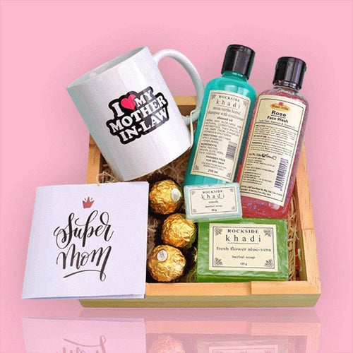 Gift basket with 'I love my mother-in-law' mug, Rockside Khadi products, and chocolates on a pink background