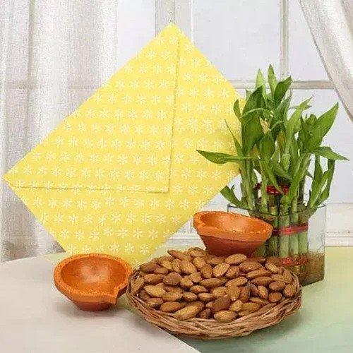 Basket of almonds, lucky bamboo plant, two clay bowls and a yellow envelope on a table