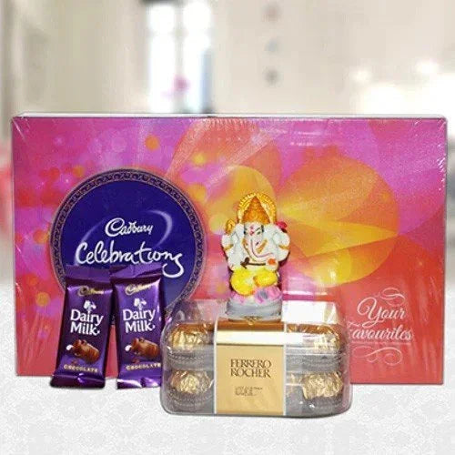 Gift set with Cadbury chocolate, Ferrero Rocher, and a small Ganesh idol in front of a colorful box.