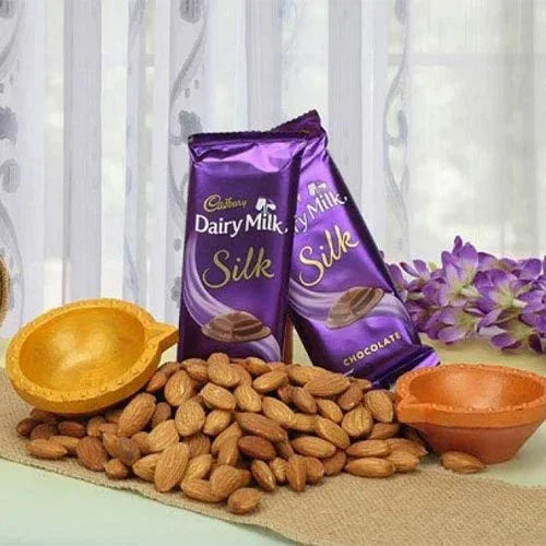 Dairy Milk Silk chocolate bars with almonds, decorative bowls, and flowers on a table
