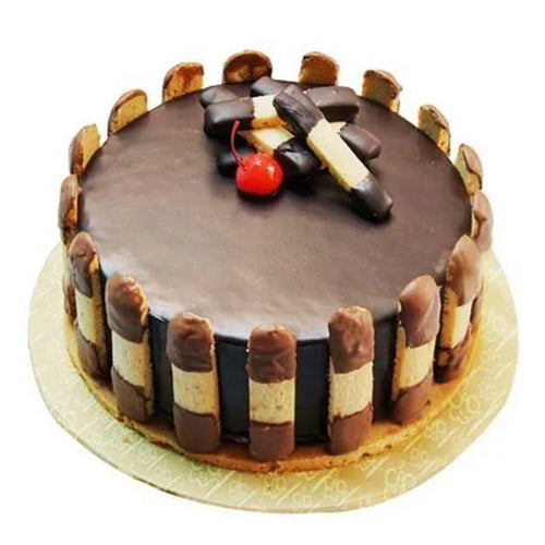 Chocolate cake with cookie decorations on a white background