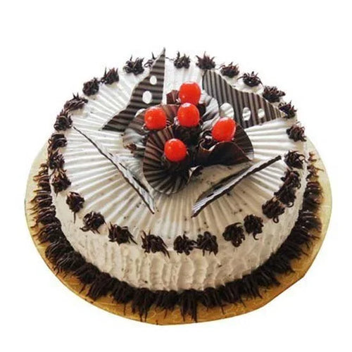 Decorative cake with chocolate shavings and red cherries on a white background