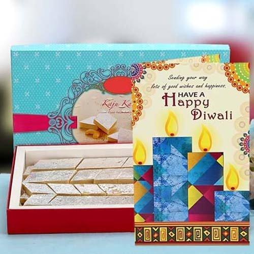 Box of sweets with a Diwali card featuring candles and colorful design.